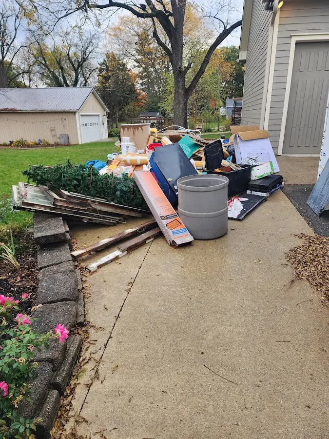 Dumpster being loaded with debris for Estate Cleanout Dumpster Rental in Oconto Falls